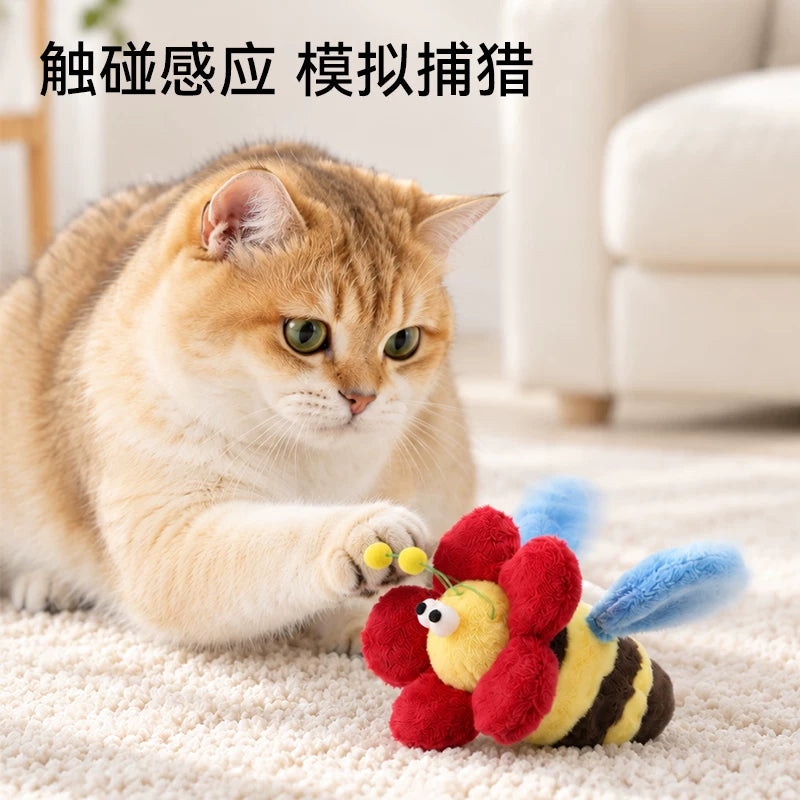 Cat pawing at the flapping bee toy